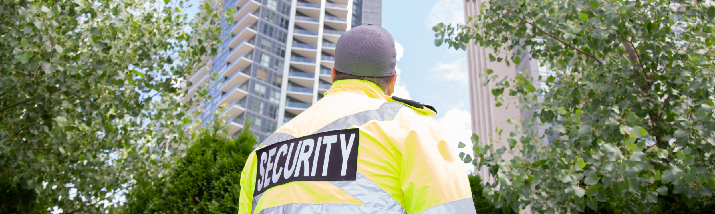 A security guard in uniform patrolling a residential area.
